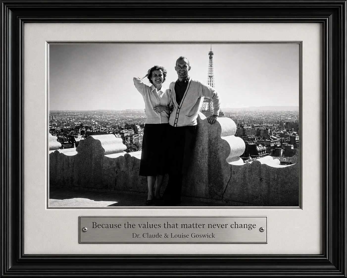 Framed archival photograph of Dr. Claude and Louise Goswick in Paris, with a plaque about enduring values.